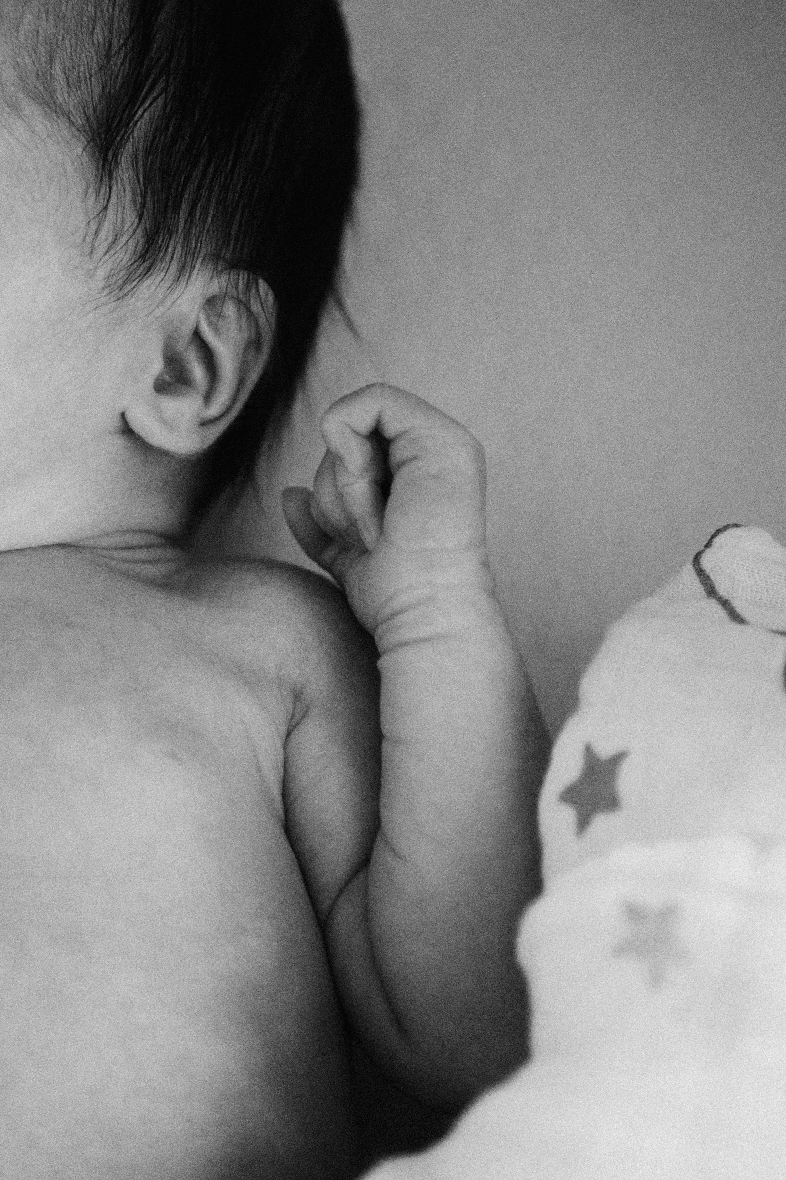 A mother holds her newborn in soft morning light.