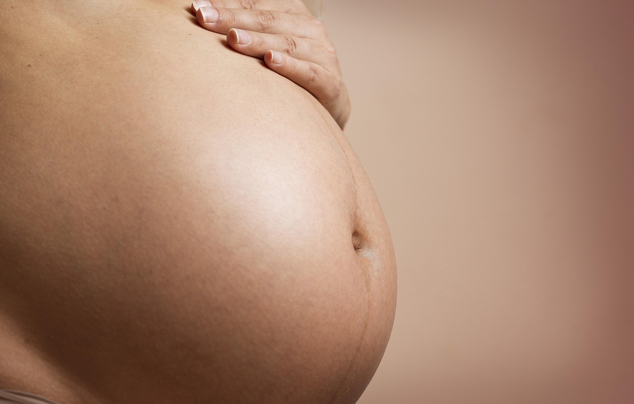 Pregnant person relaxing at home near their due date